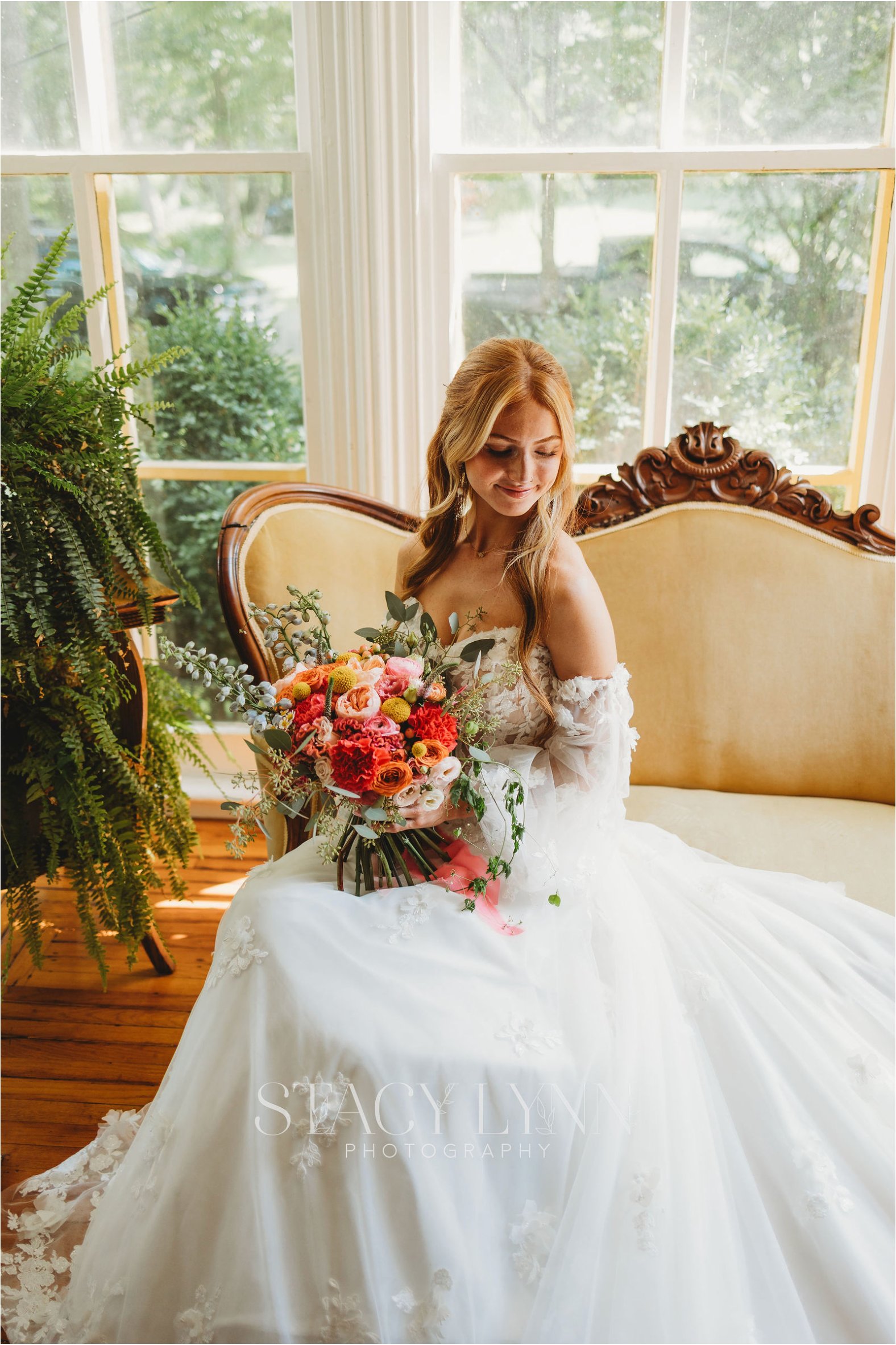 Bride with bouquet on settee