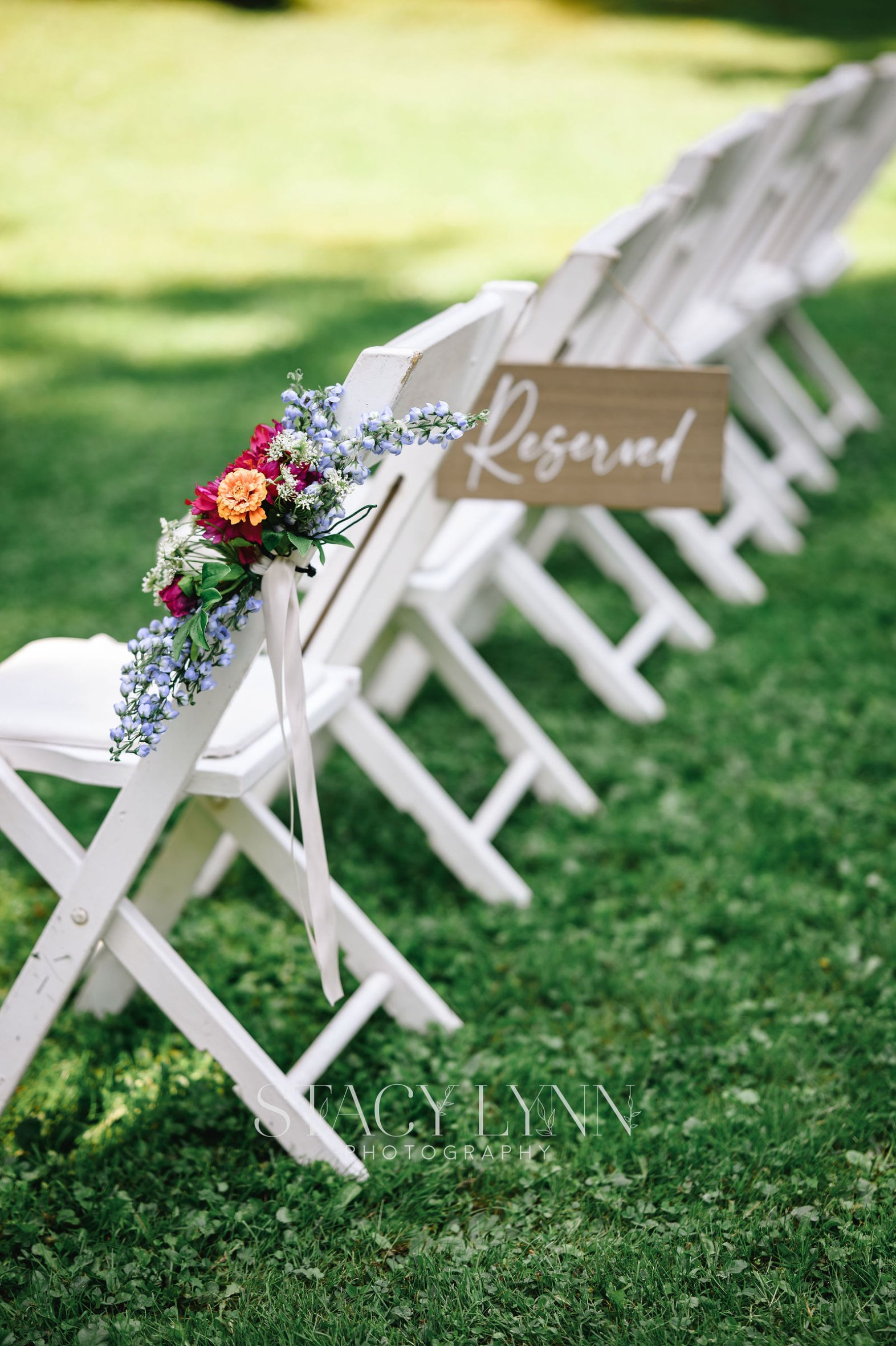Newlyweds kissing at the head table in the RED House barn