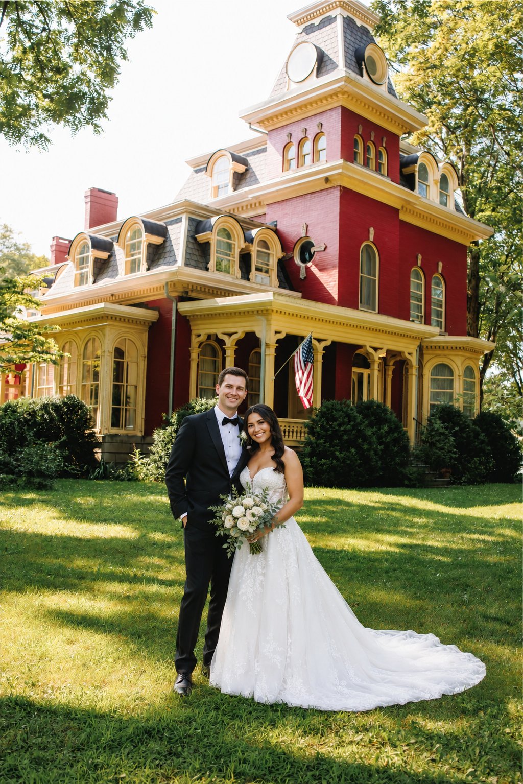Bride and groom in front of the iconic red Victorian manor at The RED House